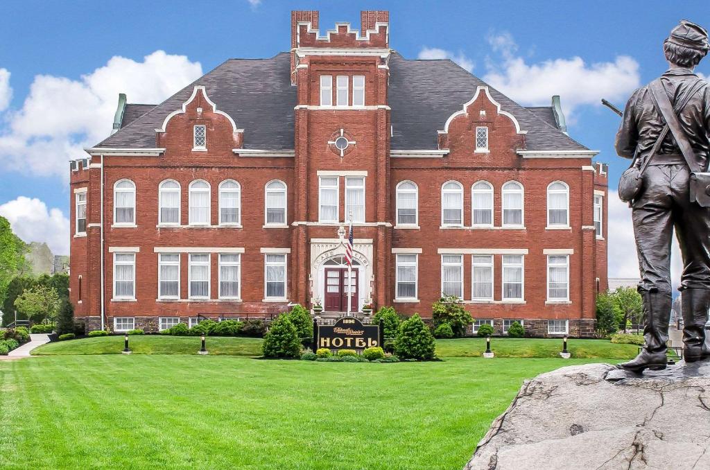 uma estátua de um homem parado em frente a um edifício em The Federal Pointe Inn Gettysburg, Ascend Hotel Collection em Gettysburg