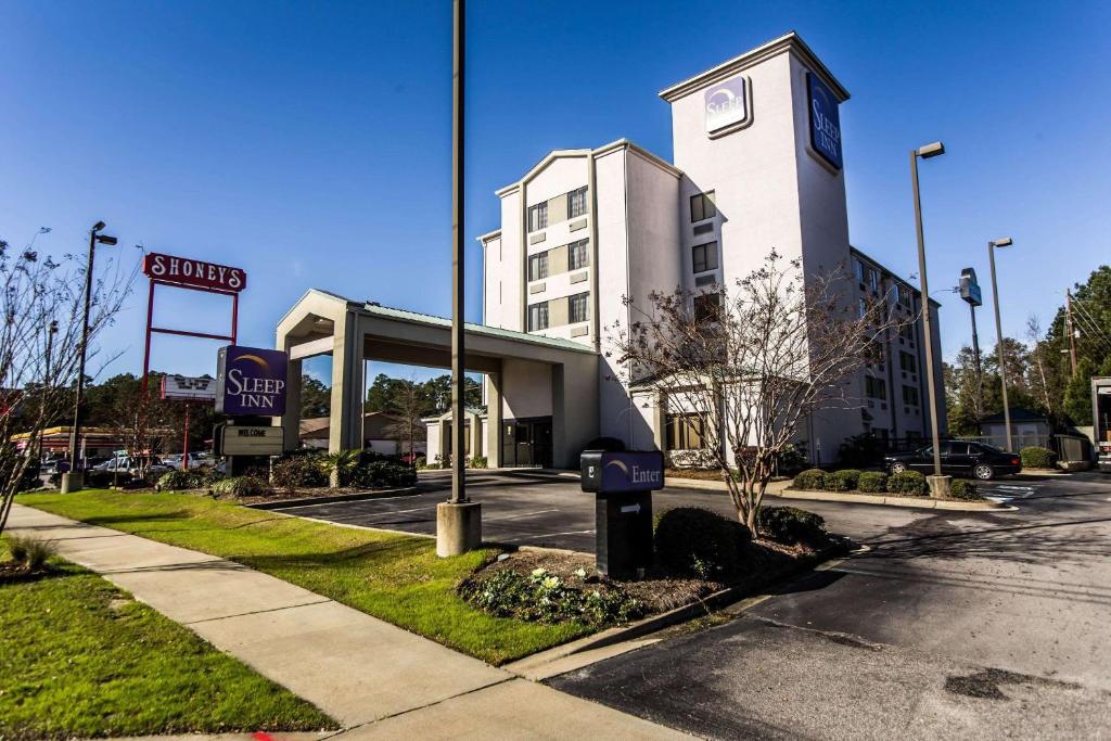 a building with a clock on the side of it at Sleep Inn Airport in Columbia