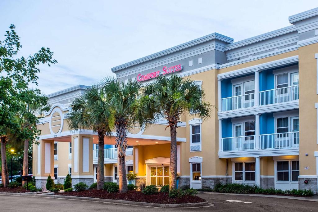 a rendering of the front of a hotel with palm trees at Comfort Suites at Isle of Palms Connector in Charleston