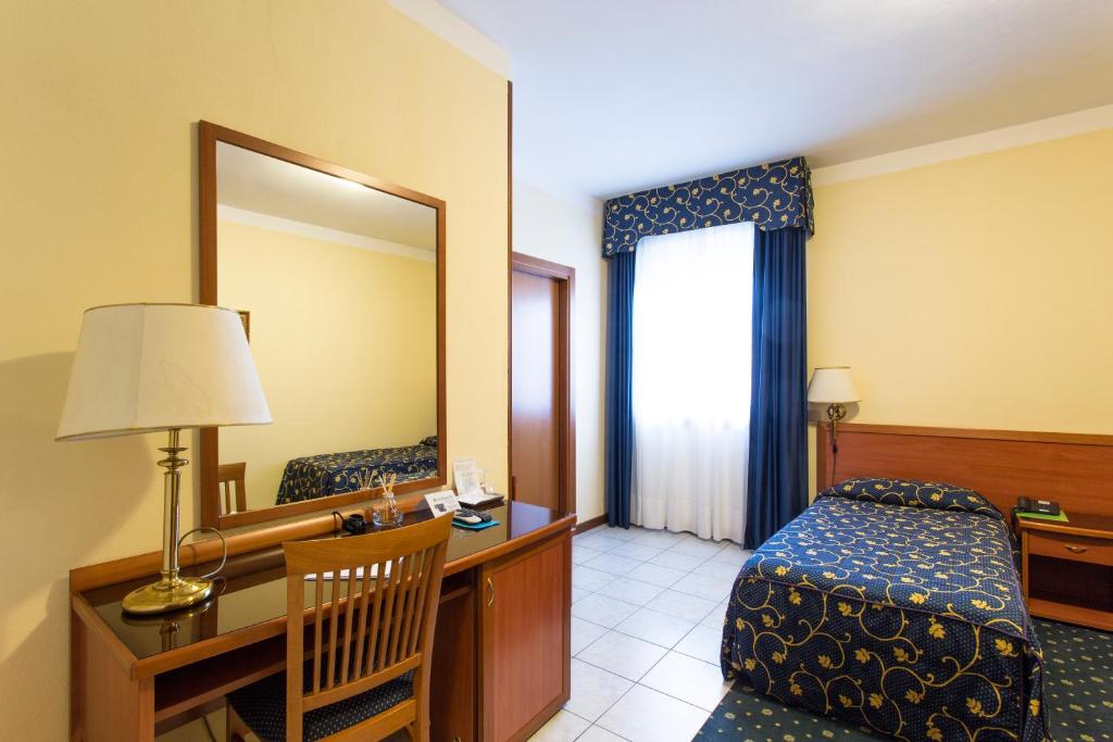 Postel nebo postele na pokoji v ubytování Hotel Ristorante Paladini