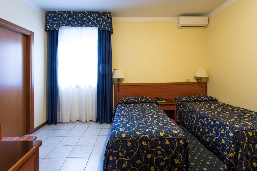 Postel nebo postele na pokoji v ubytování Hotel Ristorante Paladini