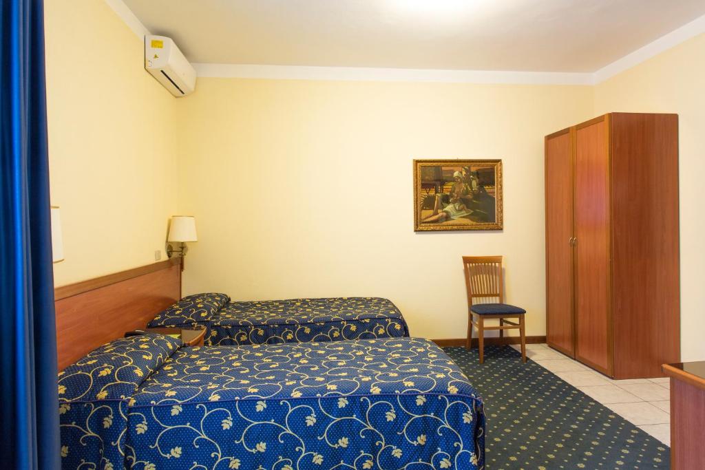 Postel nebo postele na pokoji v ubytování Hotel Ristorante Paladini