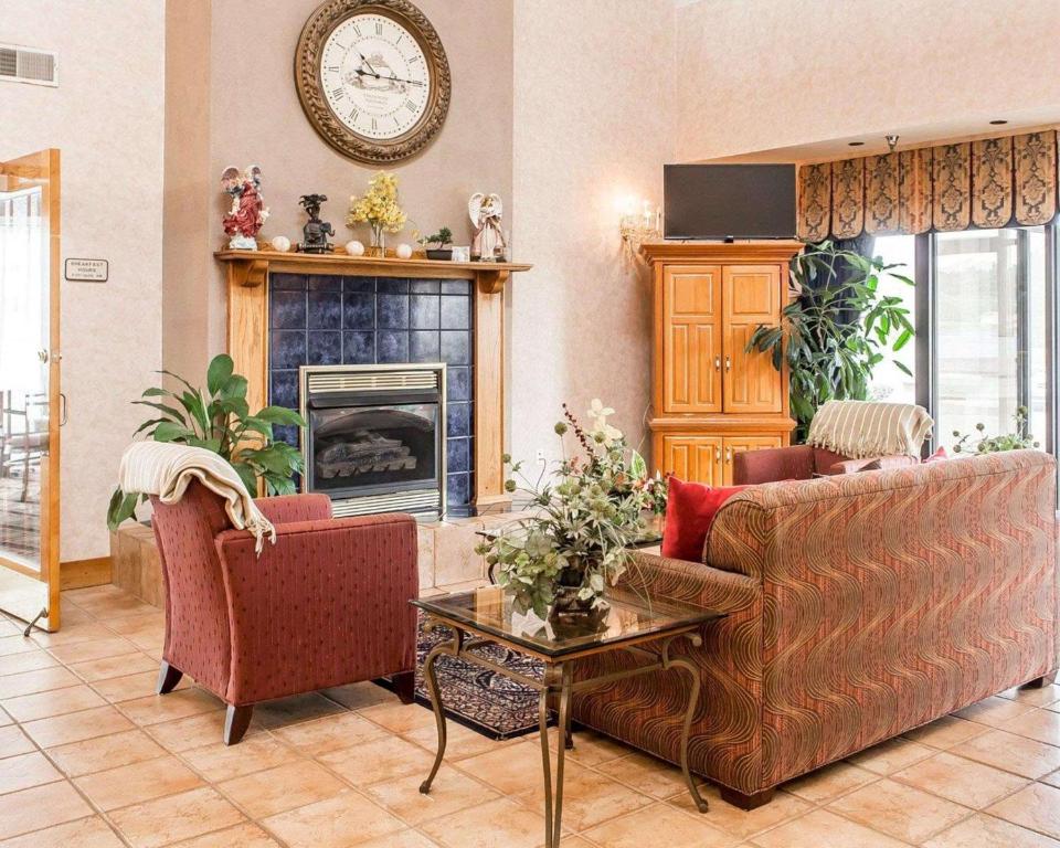 a living room with two couches and a fireplace at Econo Lodge Newport Smoky Mountains Gateway in Newport