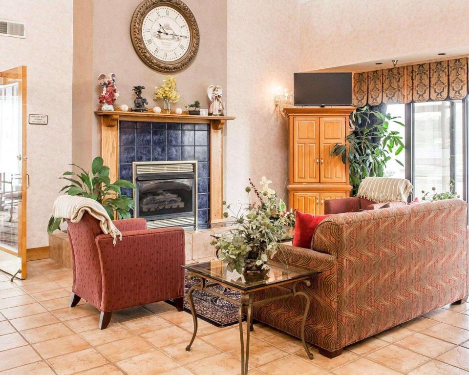 a living room with two couches and a fireplace at Econo Lodge in Newport