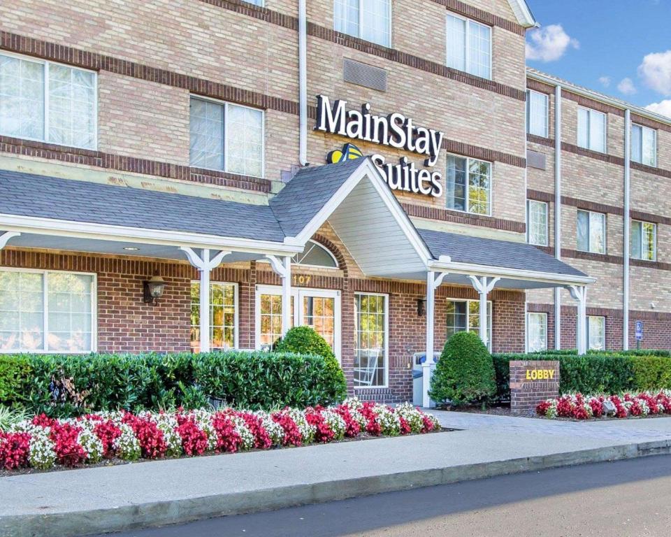 a mainstay village building with flowers in front of it at MainStay Suites Brentwood-Nashville in Brentwood