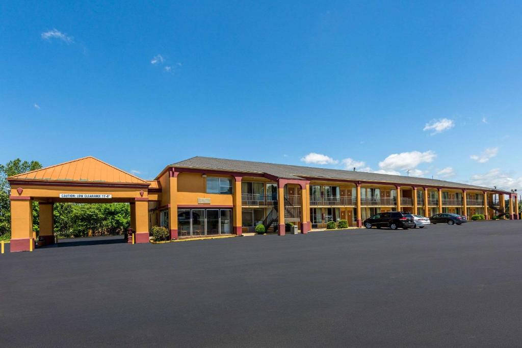 a large building with a parking lot in front of it at Rodeway Inn Denmark-Jackson in Denmark