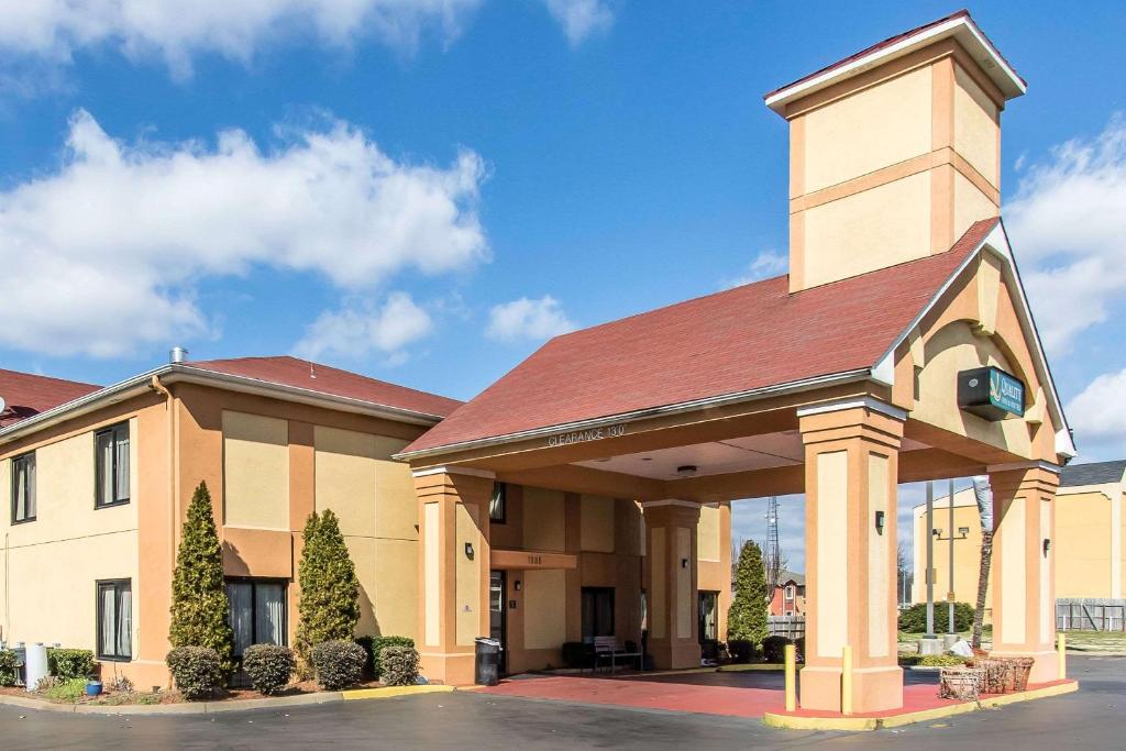 a large building with a tower on top of it at Quality Inn & Suites Memphis East in Memphis