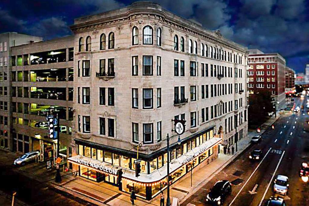 a large white building on a city street with traffic at Hotel Napoleon Memphis in Memphis