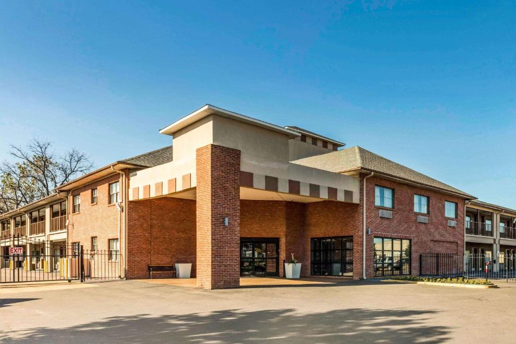 a brick building with a parking lot in front of it at Quality Inn Airport I-240 in Memphis