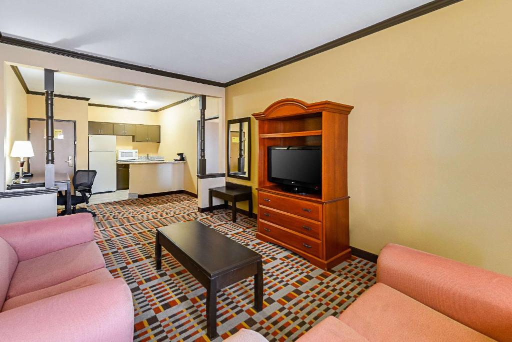 a living room with a couch and a flat screen tv at Quality Inn & Suites in Lubbock