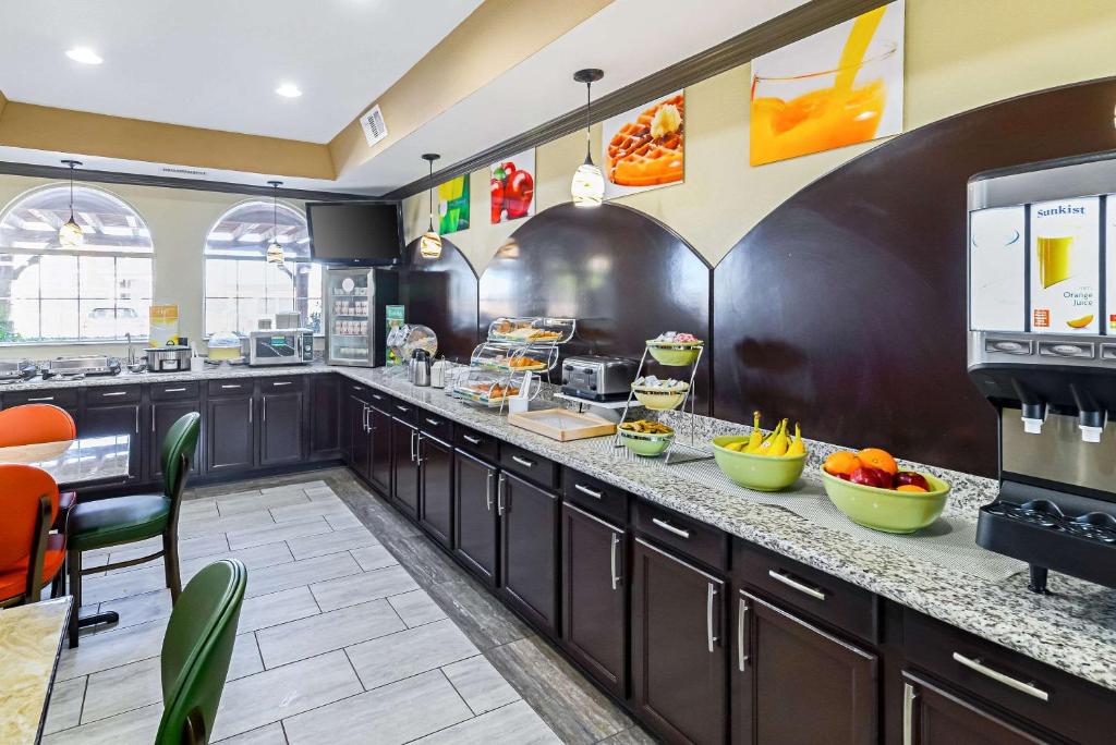 a large kitchen with a breakfast bar in a restaurant at Quality Inn & Suites in Lubbock