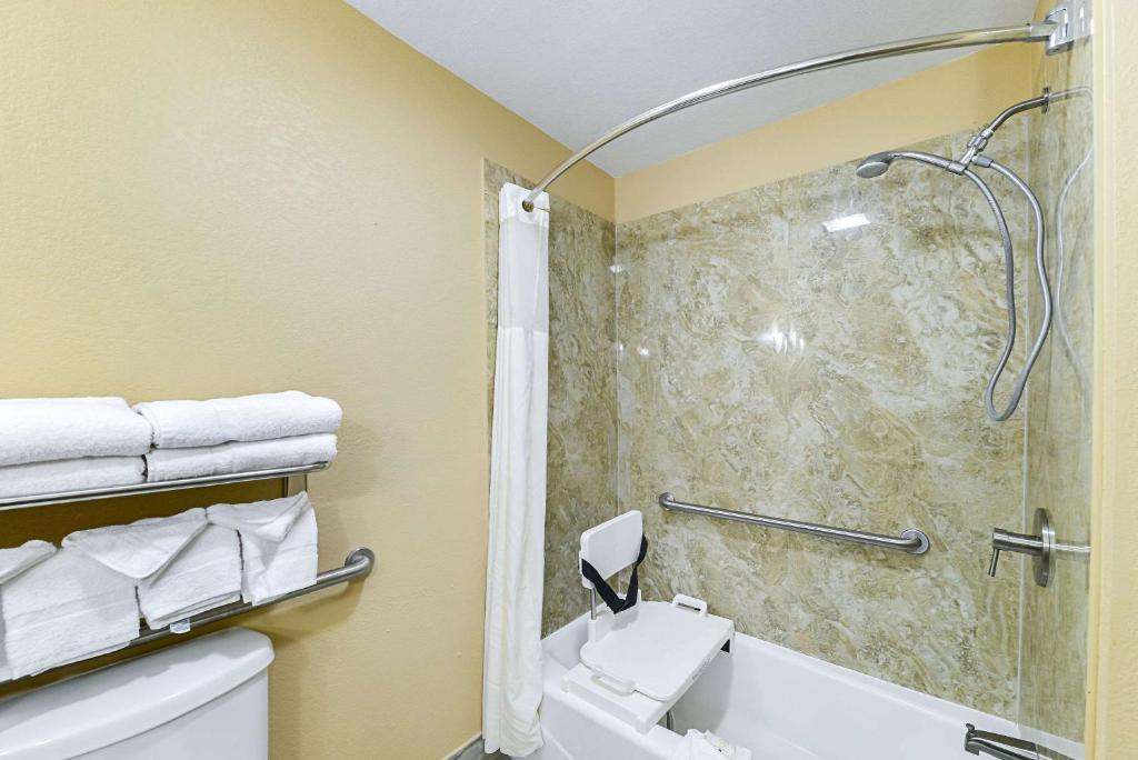 a bathroom with a shower and a toilet and a sink at Quality Inn & Suites in Lubbock