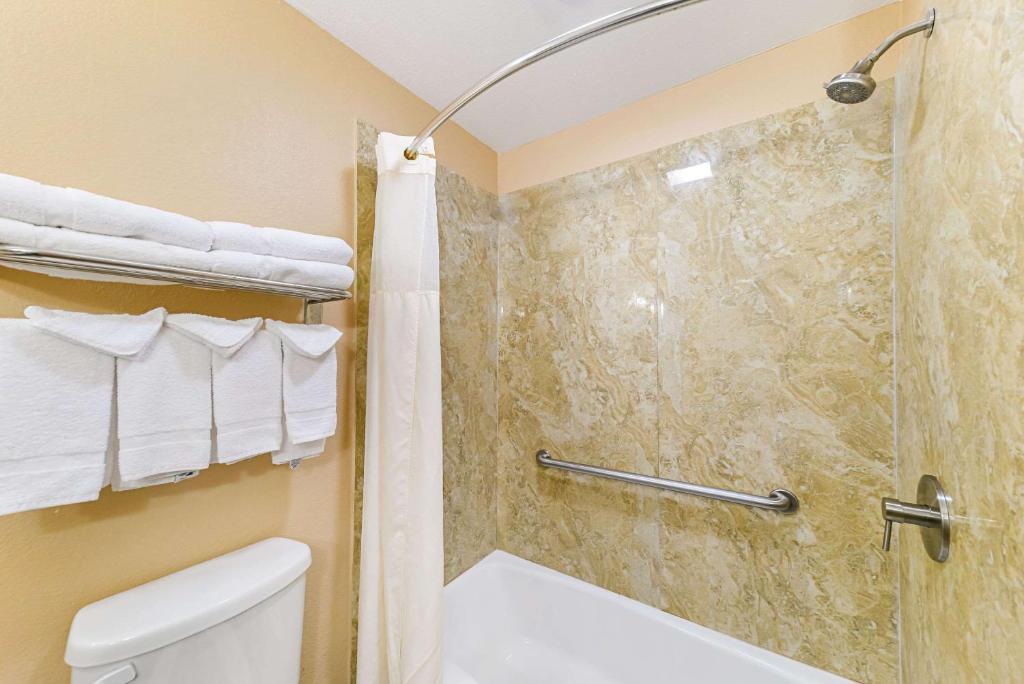 a bathroom with a shower and a toilet at Quality Inn & Suites in Lubbock