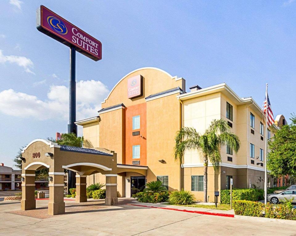 a hotel with a sign in front of a building at Comfort Suites At Plaza Mall in McAllen