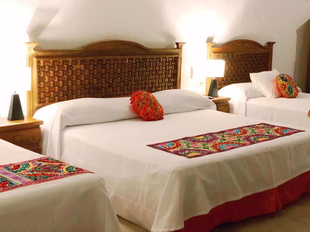 Postel nebo postele na pokoji v ubytování Hotel Real Colonial