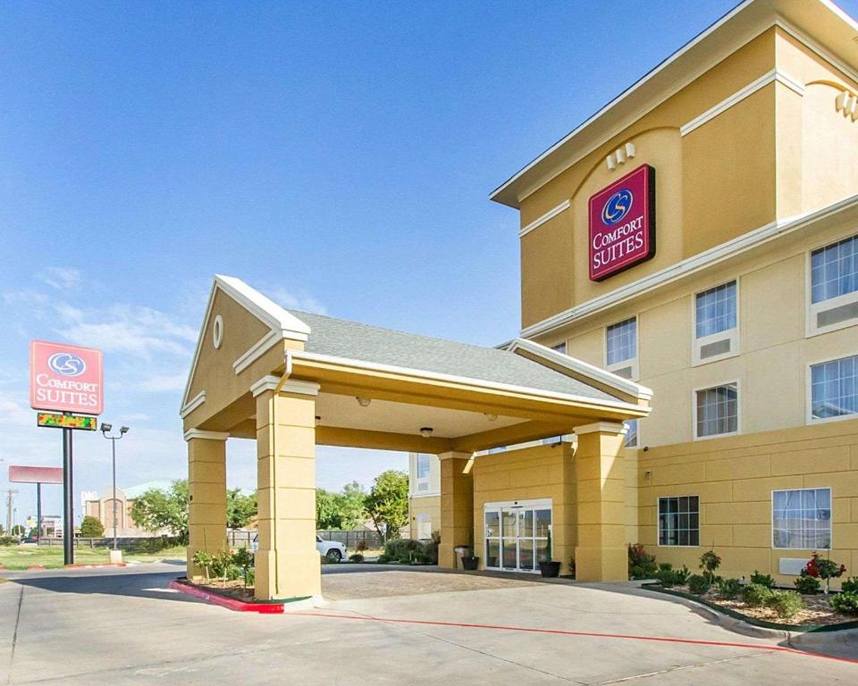 a hotel with a sign on the front of it at Comfort Suites in Abilene