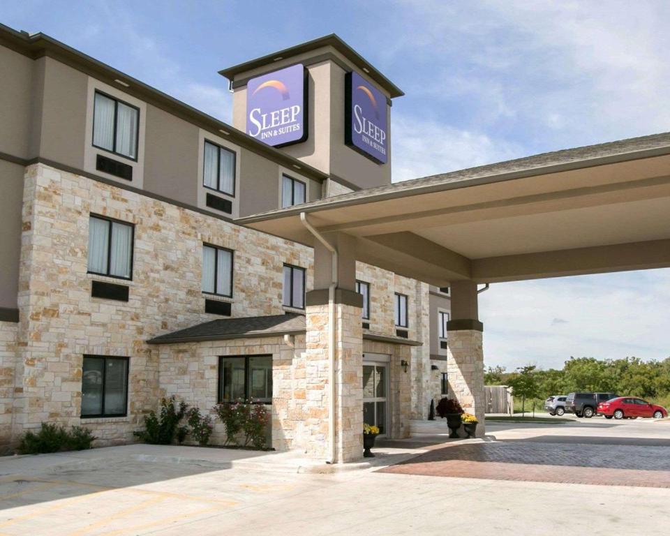 a hotel with a sign on the front of it at Sleep Inn & Suites Austin North - I-35 in Austin