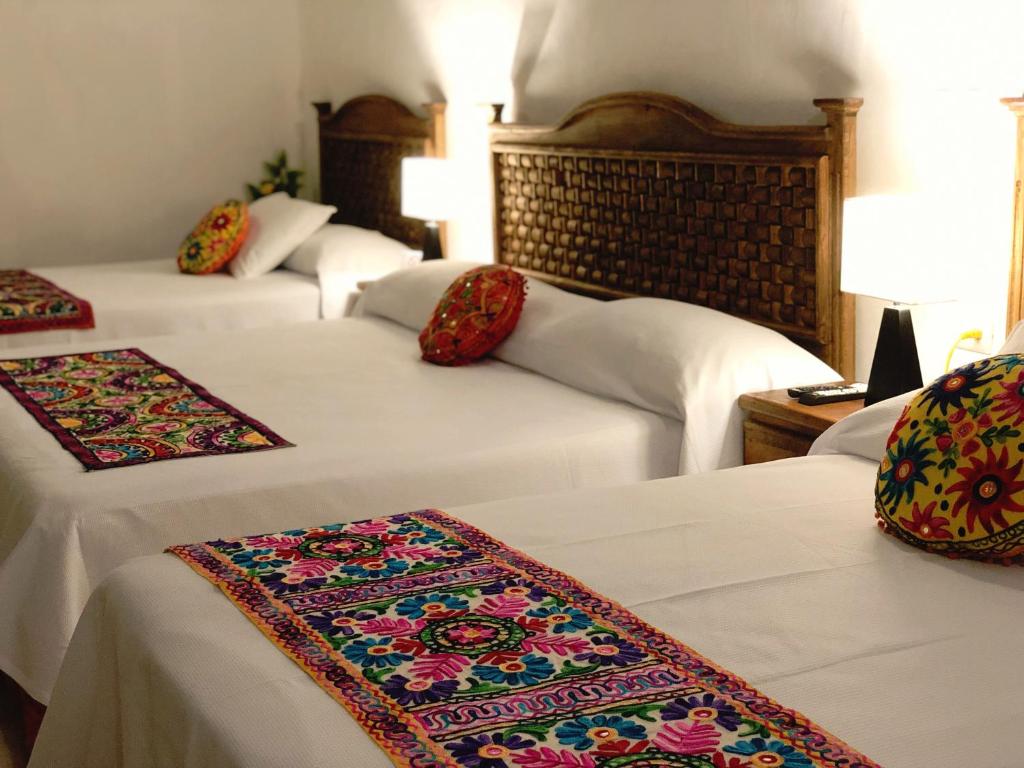 Postel nebo postele na pokoji v ubytování Hotel Real Colonial