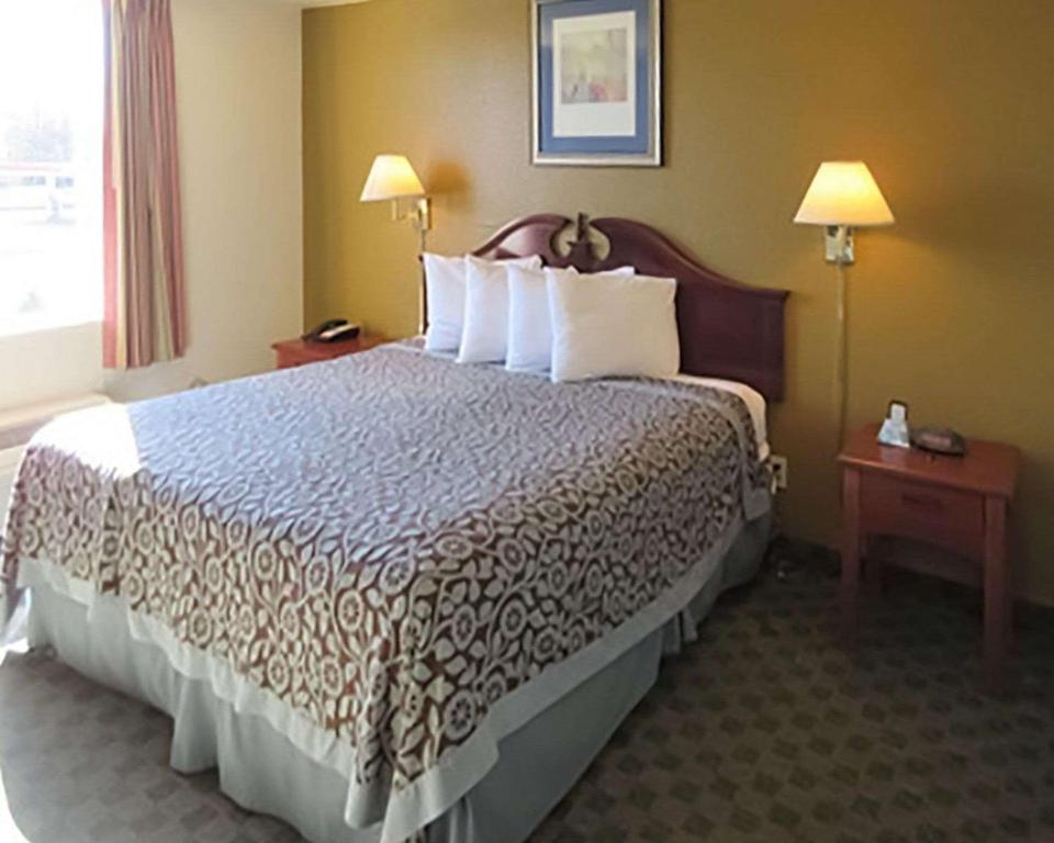 Postel nebo postele na pokoji v ubytování Rose City Inn & Suites