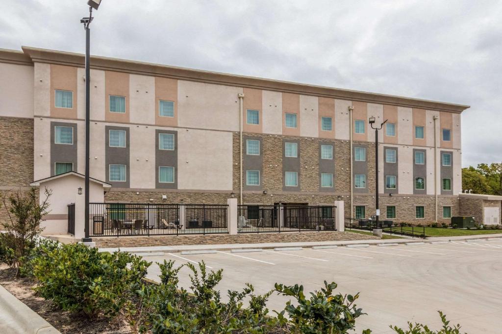 a large building with a parking lot at Sleep Inn & Suites College Station in College Station
