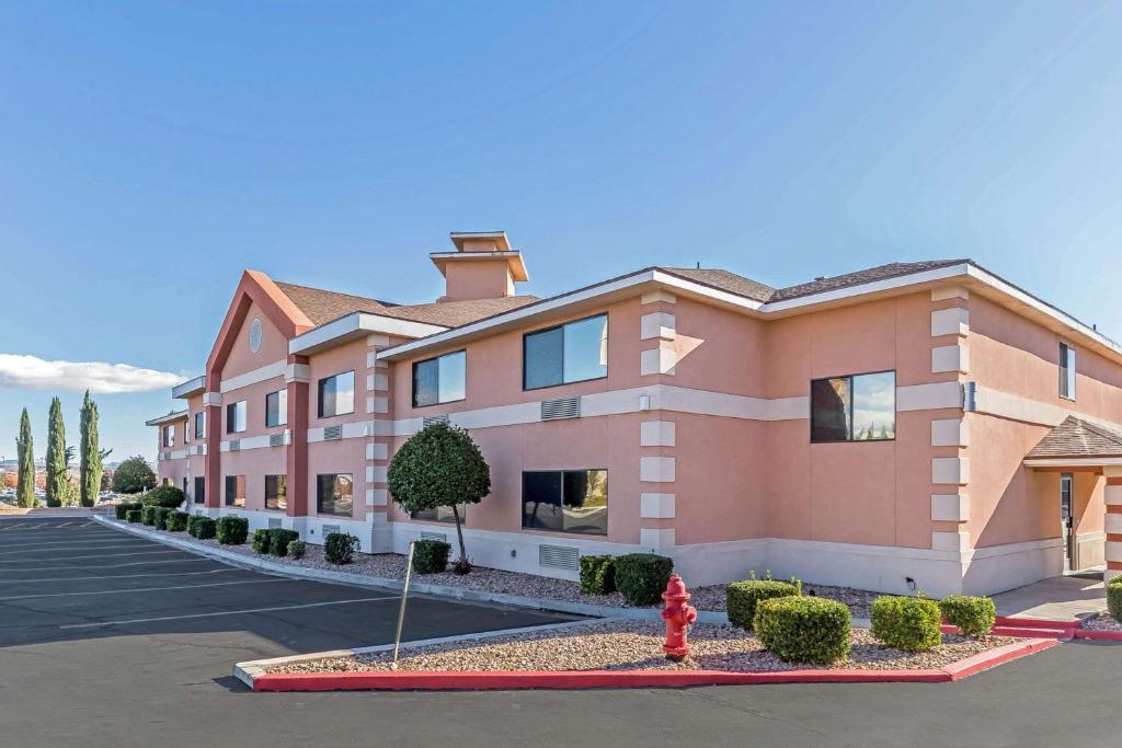 a building with a red fire hydrant in a parking lot at Quality Inn Washington - St George North in Washington