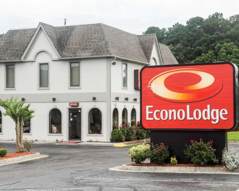 a sign in front of a building with a colomburger at Econo Lodge Chesapeake Route 13 and I-464 in Chesapeake