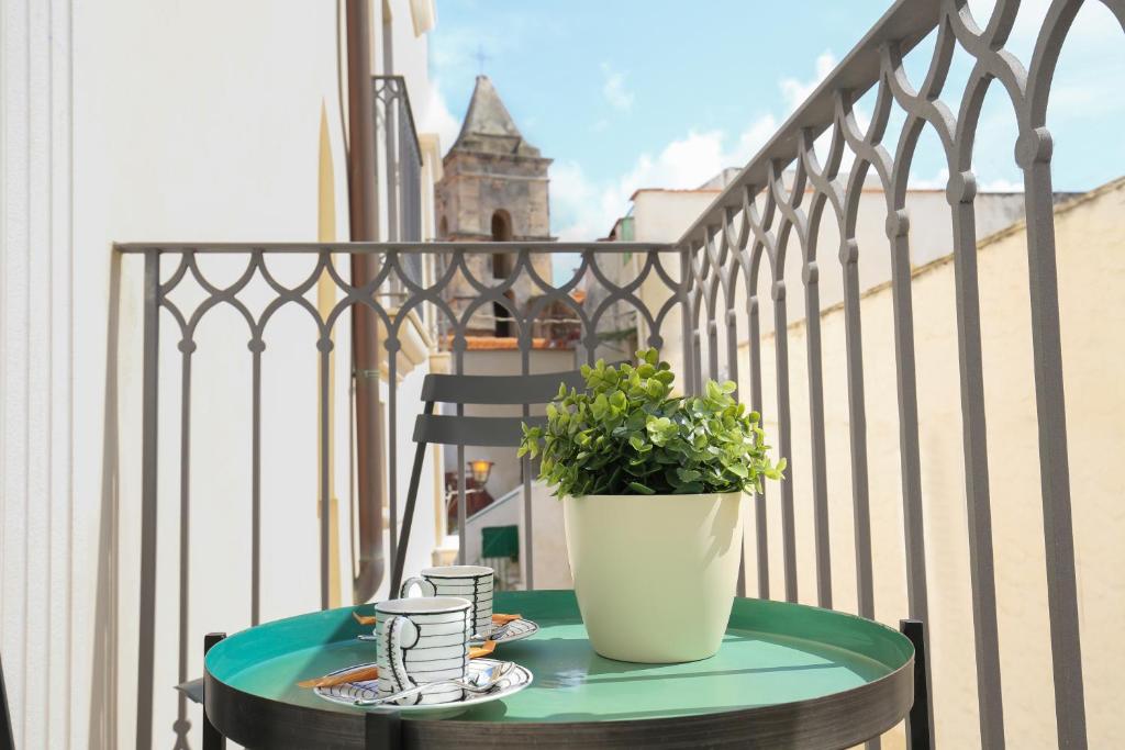 a table with a potted plant on a balcony at Al Castello Relais in Vieste