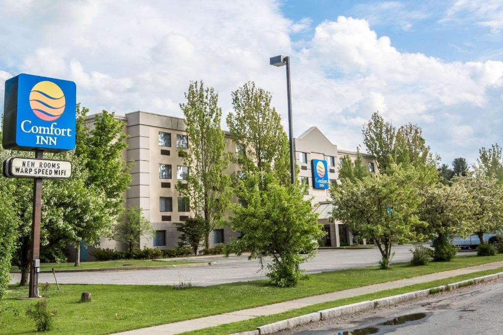 a building with a sign for a comfort inn at Comfort Inn in White River Junction