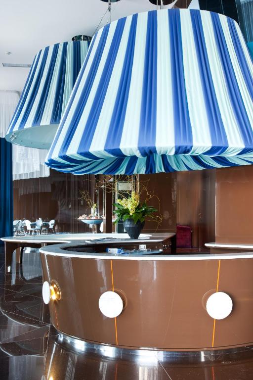 a restaurant with blue and white striped awnings at JR Hotels Bari Grande Albergo delle Nazioni in Bari