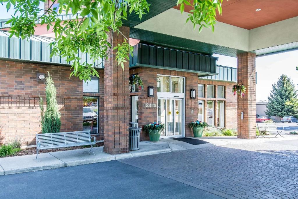 a brick building with a bench in front of it at Comfort Inn & Suites in Spokane Valley