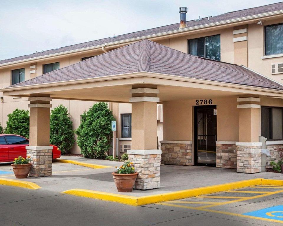 a building with a parking lot in front of it at Quality Inn in Beloit