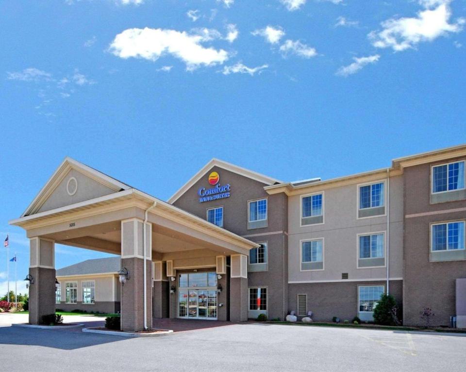 a hotel with a sign on the front of it at Comfort Inn & Suites Madison North in De Forest