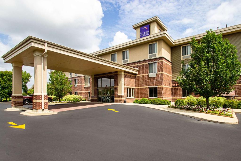 a hotel with a parking lot in front of it at Sleep Inn & Suites Madison - Monona in Madison