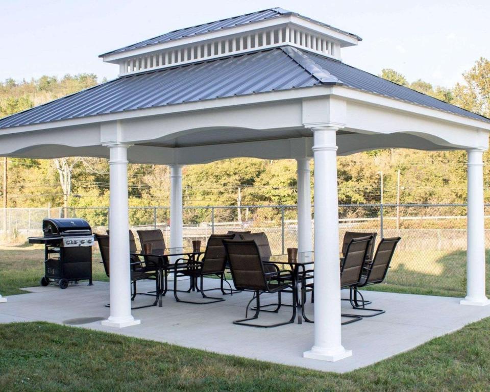 a pavilion with chairs and a table and a grill at Sleep Inn & Suites Moundsville in Moundsville