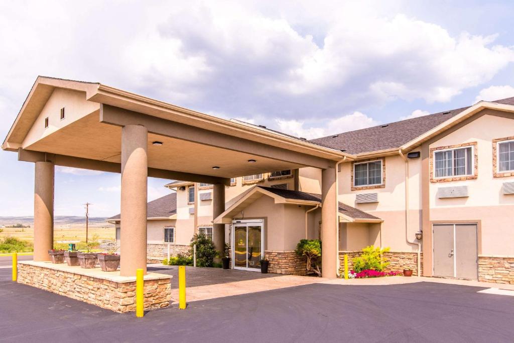 a large building with a large roof at Quality Inn & Suites University in Laramie