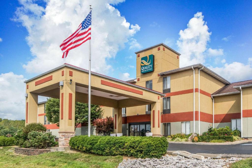 a hotel with an american flag in front of it at Quality Inn & Suites in Lawrenceburg