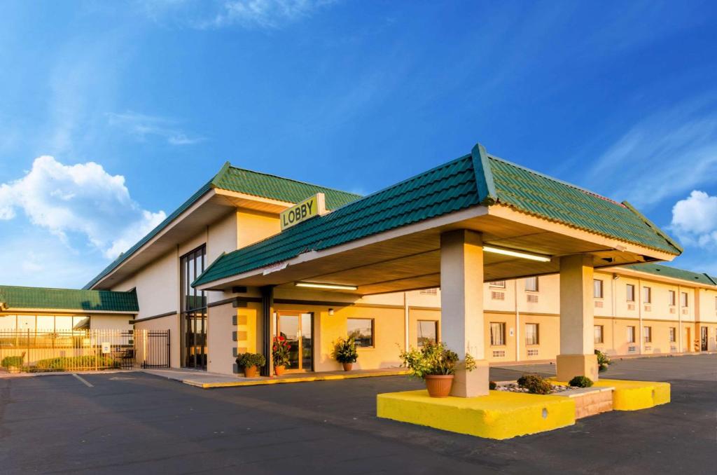 a large building with a green roof at Quality Inn & Suites Salina in Salina