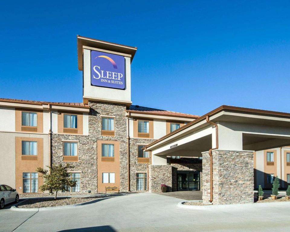 a hotel with a sign on the front of it at Sleep Inn & Suites Norton in Norton