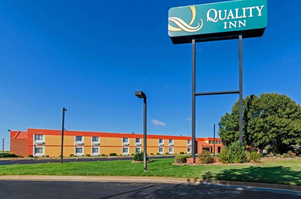 a sign for a quality inn in front of a building at Quality Inn South in Wichita