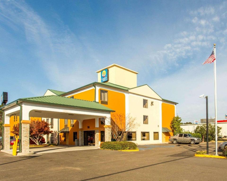 a hotel with an american flag in front of it at Comfort Inn Hammond in Hammond