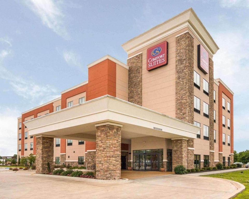 a hotel building with a sign on the front of it at Comfort Suites Bossier City - Shreveport East in Bossier City