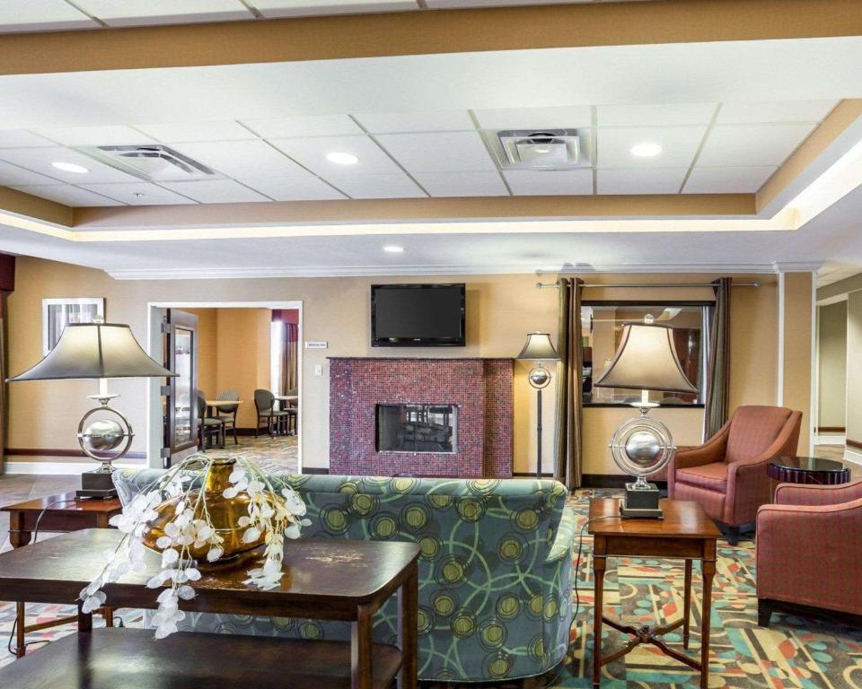 a living room with a couch and a fireplace at Quality Inn Donaldsonville - Gonzales in Donaldsonville
