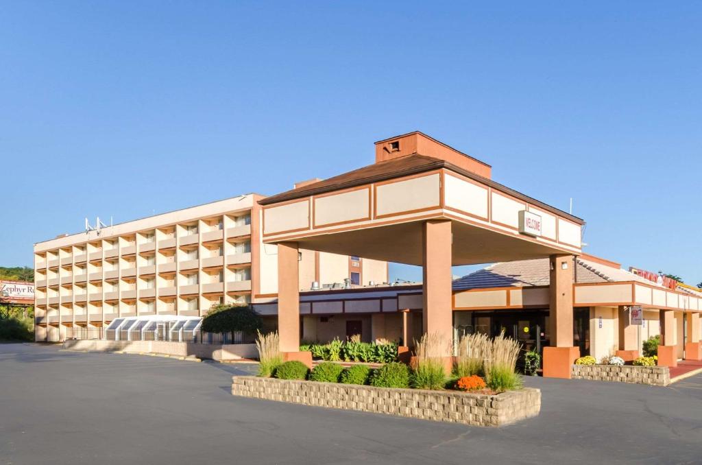 a large hotel building with a parking lot at Quality Inn West Springfield in West Springfield