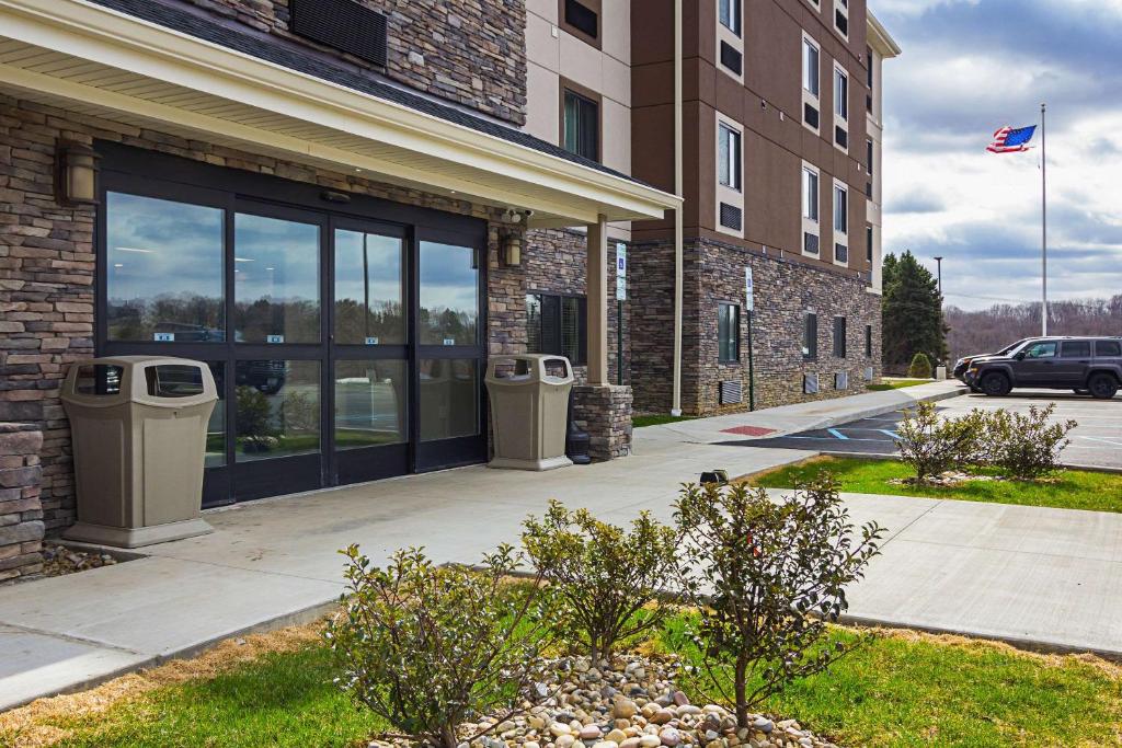 a building with two trash cans in front of it at Suburban Studios Monaca - Pittsburgh in Monaca