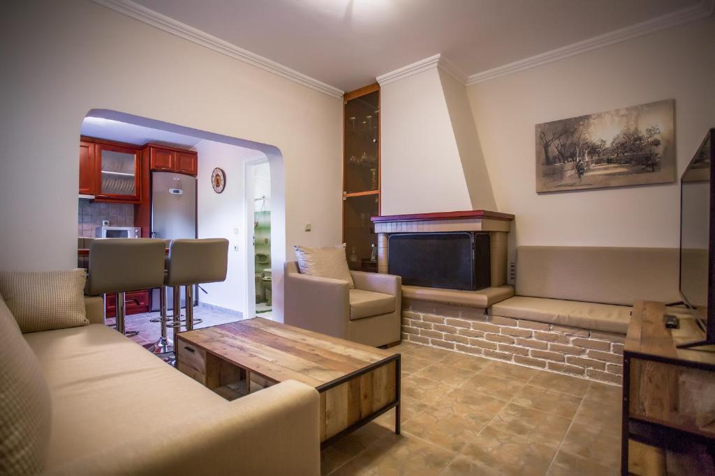 a living room with a couch and a table at Natural Beauty Spot in Áno Garoúna