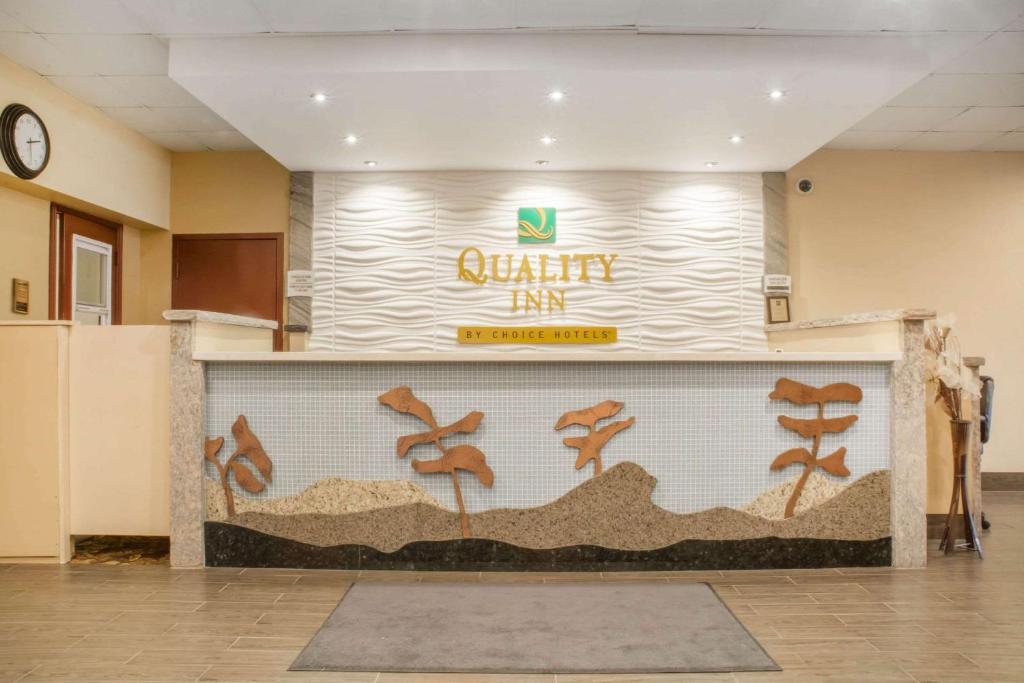 a restaurant with a wall with a sign on it at Quality Inn in Bracebridge