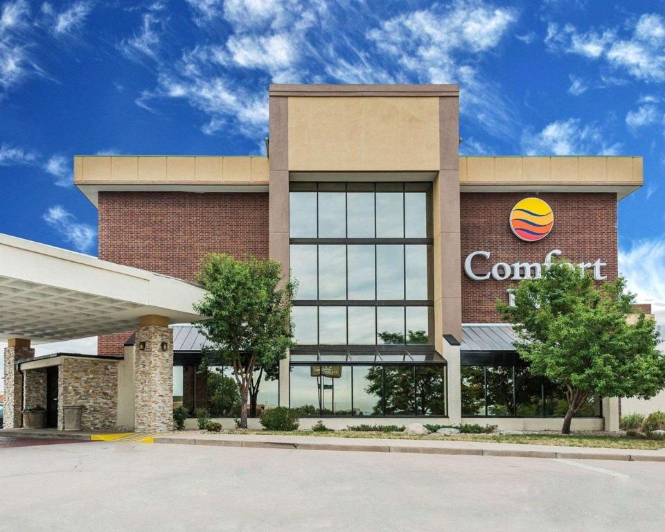 a large building with a sign in front of it at Comfort Inn Denver East in Denver