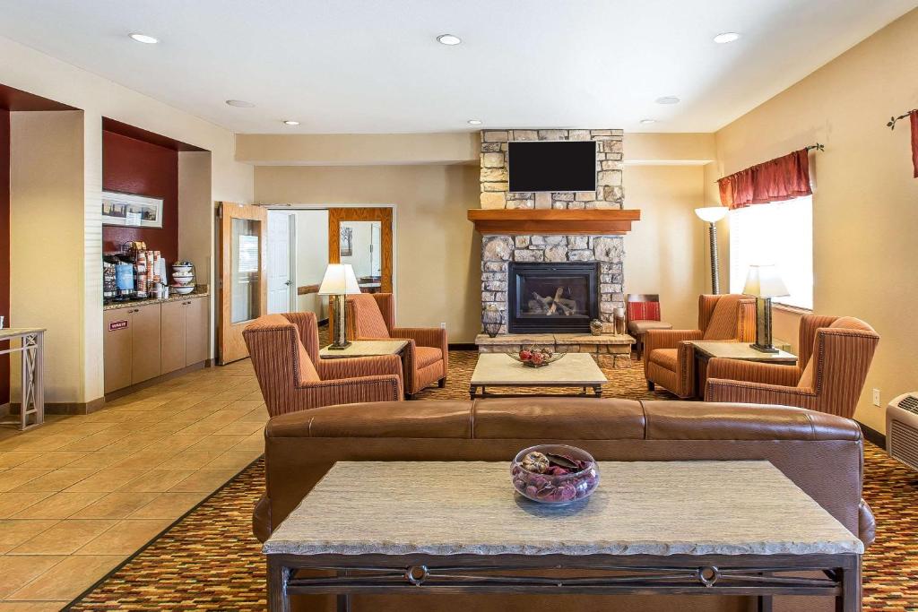 a living room with a couch and a fireplace at Quality Inn & Suites Loveland in Loveland