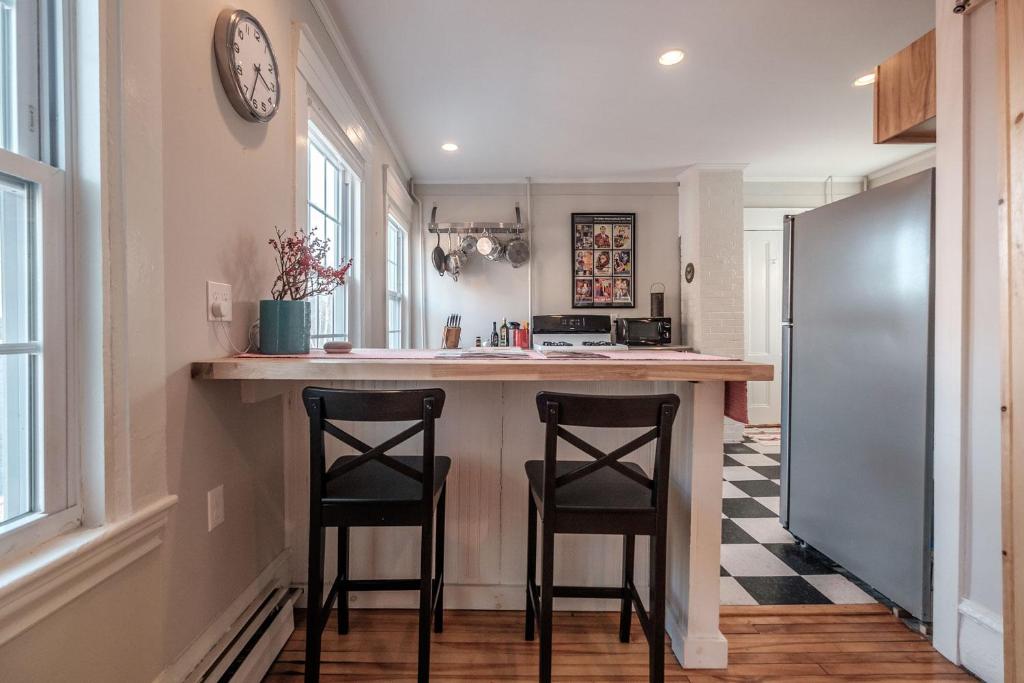 a kitchen with two stools at a kitchen island at Haven on the Hill in Portland