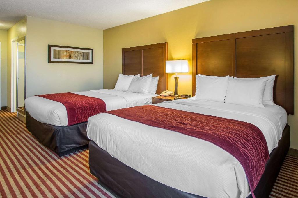 a hotel room with two beds and two lamps at Comfort Inn at the parks in Orlando